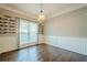 Dining room with decorative wainscoting, modern chandelier, and hardwood floors at 875 Soaring Cir, Marietta, GA 30062