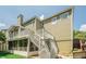 Back exterior of home featuring a sunroom, deck and multiple staircases at 875 Soaring Cir, Marietta, GA 30062