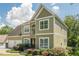 Two-story home with stone accents, a three-car garage, and well-manicured landscaping at 875 Soaring Cir, Marietta, GA 30062
