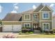 Two-story home with a three car garage, stone accents, and beautiful curb appeal at 875 Soaring Cir, Marietta, GA 30062