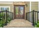 Elegant stone entryway with double front doors and wrought iron railing at 875 Soaring Cir, Marietta, GA 30062