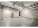 Large garage with two doors, gray floors, overhead storage, and a refrigerator at 875 Soaring Cir, Marietta, GA 30062