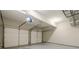 Empty two car garage featuring two garage doors and light gray floors at 875 Soaring Cir, Marietta, GA 30062