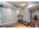 Home gym area featuring a treadmill, hardwood floors, and ample lighting at 875 Soaring Cir, Marietta, GA 30062