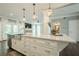 Spacious kitchen offers granite countertops, white cabinets, stainless steel appliances, a tile backsplash and hardwood floors at 875 Soaring Cir, Marietta, GA 30062