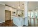 Bright kitchen features white cabinets, stainless steel appliances, granite countertops and dark hardwood floors at 875 Soaring Cir, Marietta, GA 30062