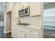 Eat-in kitchen features white cabinets, granite countertops, stainless steel appliances, tile backsplash and hardwood floors at 875 Soaring Cir, Marietta, GA 30062