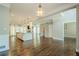 An open concept living room and kitchen with hardwood flooring, stone fireplace, and modern finishes at 875 Soaring Cir, Marietta, GA 30062