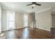 Living room offers hardwood floors, neutral paint, white curtains, and a staircase to the second level at 875 Soaring Cir, Marietta, GA 30062
