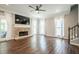 Living room with a stone fireplace, hardwood floors, neutral paint and a ceiling fan at 875 Soaring Cir, Marietta, GA 30062