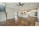 Bright open-plan living area with modern kitchen, hardwood floors, and staircase at 875 Soaring Cir, Marietta, GA 30062