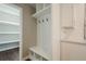 Mudroom with shiplap, storage cubbies and a bench, located next to the kitchen pantry at 875 Soaring Cir, Marietta, GA 30062