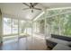 Bright sunroom features wood floors, a ceiling fan, and sliding glass doors to the outside at 875 Soaring Cir, Marietta, GA 30062