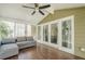 Open sunroom with wood flooring, a ceiling fan, and large glass windows at 875 Soaring Cir, Marietta, GA 30062