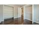 Walk-in closet with shelving, rod, hardwood floors, and doorway to bathroom at 875 Soaring Cir, Marietta, GA 30062