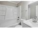 Clean bathroom featuring white cabinets, countertop, and shower-tub combo at 1696 Thomas St, Decatur, GA 30032