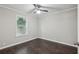 Bedroom featuring ceiling fan, dark wood flooring, window with blinds, and neutral walls at 1696 Thomas St, Decatur, GA 30032