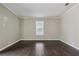 Neutral bedroom features dark wood floors and a bright window at 1696 Thomas St, Decatur, GA 30032