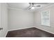 Bedroom with ceiling fan, dark wood flooring, window with blinds, neutral paint color at 1696 Thomas St, Decatur, GA 30032