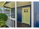 Inviting front porch features a vibrant yellow door and freshly painted railings at 1696 Thomas St, Decatur, GA 30032