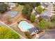 An aerial view of a pool area and a community building in a residential neighborhood at 245 Weatherstone Pointe Dr, Woodstock, GA 30188