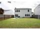 Spacious backyard with a well-kept lawn, surrounded by a wooden fence, providing a private outdoor area at 245 Weatherstone Pointe Dr, Woodstock, GA 30188
