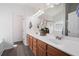Well-lit bathroom with double vanity, a large mirror, and wood flooring, offering a stylish and functional space at 245 Weatherstone Pointe Dr, Woodstock, GA 30188