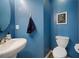 Stylish half bathroom featuring modern fixtures and blue accent walls at 245 Weatherstone Pointe Dr, Woodstock, GA 30188