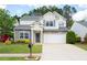 Beautiful two-story home boasts stone accents, a manicured lawn and inviting curb appeal at 245 Weatherstone Pointe Dr, Woodstock, GA 30188