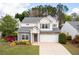 Charming two-story home featuring stone accents, a well-manicured lawn, and an attached two-car garage at 245 Weatherstone Pointe Dr, Woodstock, GA 30188