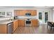 Charming kitchen with stainless steel appliances, wood cabinets and backyard view at 245 Weatherstone Pointe Dr, Woodstock, GA 30188