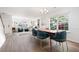 Open-concept living and dining room space with hardwood flooring, bright white walls, and modern furnishings at 245 Weatherstone Pointe Dr, Woodstock, GA 30188