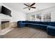 Spacious living room with a comfortable blue sectional sofa, fireplace, and hardwood flooring at 245 Weatherstone Pointe Dr, Woodstock, GA 30188