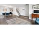 Open-concept living and dining area with hardwood floors, bright walls, and a contemporary design at 245 Weatherstone Pointe Dr, Woodstock, GA 30188