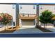 Rear exterior view of a modern townhouse with a wooden balcony and attached garage at 3057 Windover Ln, Kennesaw, GA 30144