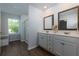 This bathroom offers double sinks, vanity and modern wood look flooring and natural light at 3057 Windover Ln, Kennesaw, GA 30144
