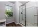 Bathroom with a glass-enclosed shower and a window for natural light at 3057 Windover Ln, Kennesaw, GA 30144