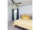 This bedroom features neutral walls, carpet, a fan, and a bed with yellow covers at 3057 Windover Ln, Kennesaw, GA 30144