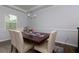 Bright dining room featuring a wooden table, white chairs, and a light fixture at 3057 Windover Ln, Kennesaw, GA 30144
