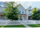 Inviting two-story home showcases a classic white picket fence and lush green trees at 3057 Windover Ln, Kennesaw, GA 30144