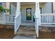 Inviting front porch with stone steps and a classic white railing leading to the front door at 3057 Windover Ln, Kennesaw, GA 30144