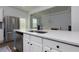 White kitchen with stainless appliances and light counters open to eating area at 3057 Windover Ln, Kennesaw, GA 30144