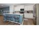 Modern kitchen with white cabinets, stainless steel appliances, and a blue island with seating at 3057 Windover Ln, Kennesaw, GA 30144