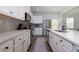 Bright kitchen features white cabinetry, stainless appliances, and a kitchen island at 3057 Windover Ln, Kennesaw, GA 30144