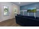 Living room with blue accent wall, cozy blue sofa, and a door to the outside at 3057 Windover Ln, Kennesaw, GA 30144