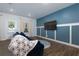 Blue living room with board and batten accent wall and view to backyard at 3057 Windover Ln, Kennesaw, GA 30144