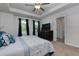 Primary bedroom featuring a tray ceiling, plush carpet, and ensuite bathroom at 3057 Windover Ln, Kennesaw, GA 30144