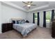 Primary bedroom featuring a tray ceiling, plush carpet, and ensuite bathroom at 3057 Windover Ln, Kennesaw, GA 30144