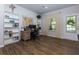 Inviting home office with wood-look floors, built-in shelving and a world map feature at 3057 Windover Ln, Kennesaw, GA 30144