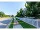 A row of townhomes with a white picket fence lining the sidewalk at 3057 Windover Ln, Kennesaw, GA 30144